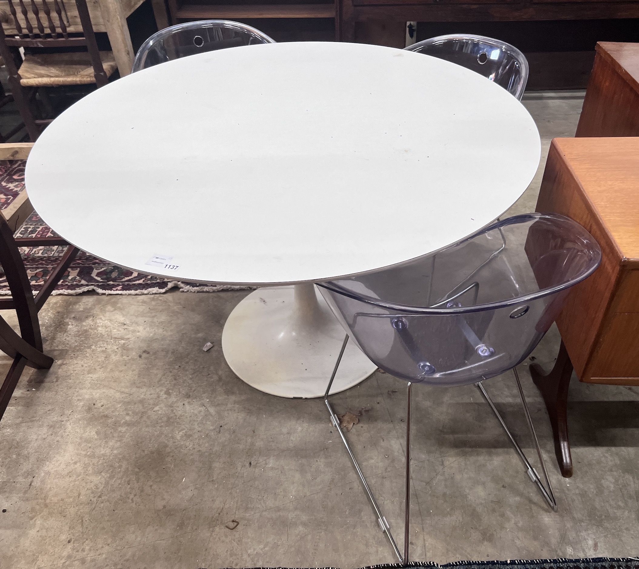 Three Habitat perspex armchairs and a Habitat ‘’Chelsea’’ circular white laminated wood table, diameter 120cm, height 72cm (3)